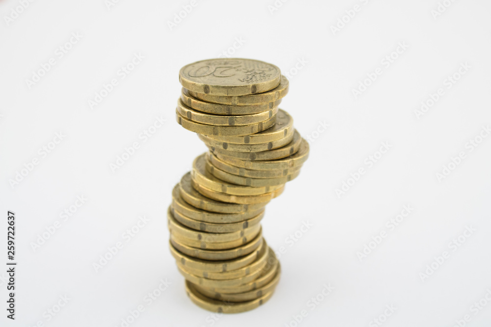 Unstable economy. Stack twenty euro cent coins on white background. Savings. Unstable economy. Stack twenty euro cent coins on white background. Savings.
