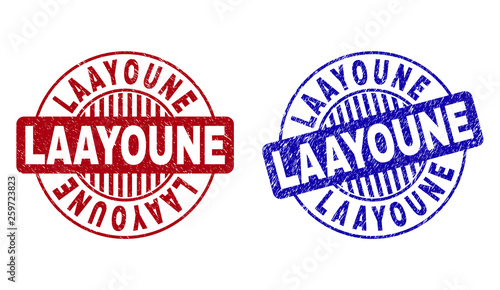 Grunge LAAYOUNE round stamp seals isolated on a white background. Round seals with grunge texture in red and blue colors. Vector rubber imprint of LAAYOUNE caption inside circle form with stripes.