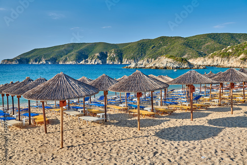 Beach with loungers and umbrellas in Greece