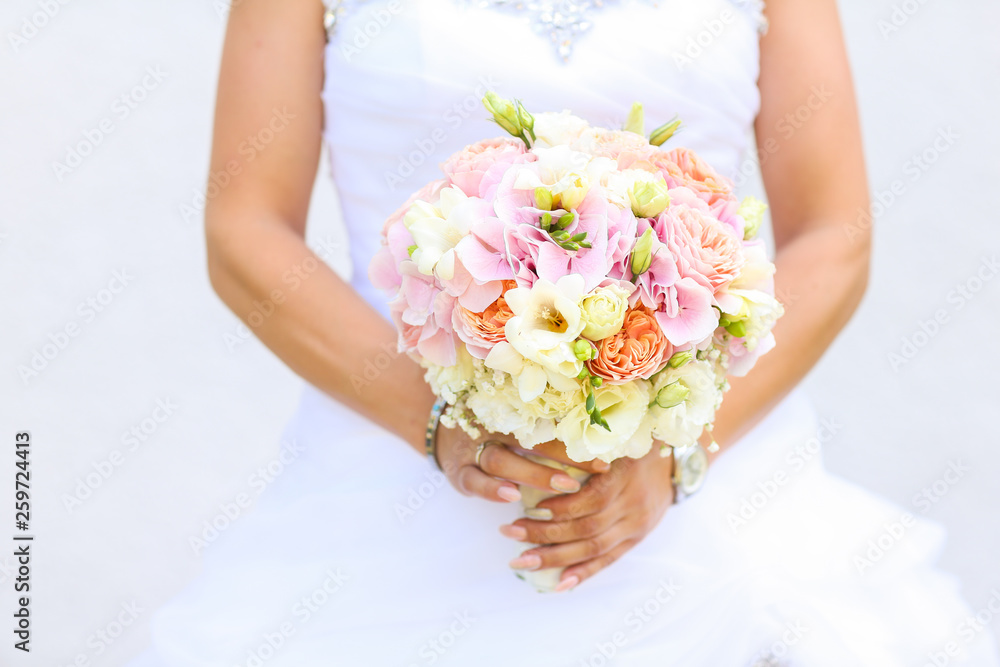 Bride holding a beautiful bouquet of flowers in hands Bride holding a beautiful bouquet of flowers in hands