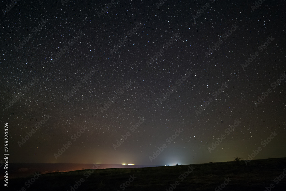 Bright stars in the night sky with lighting from the street lamps of the city. Light pollution. Bright stars in the night sky with lighting from the street lamps of the city. Light pollution.
