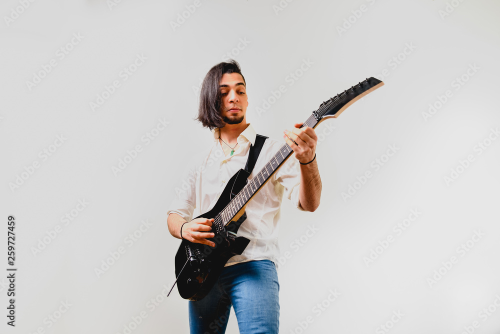Young guitar player isolated on white background.