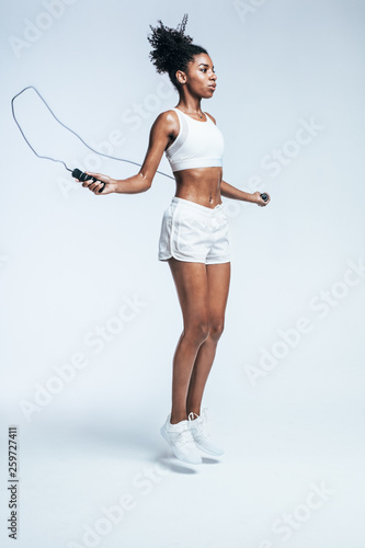 Healthy young woman skippin...