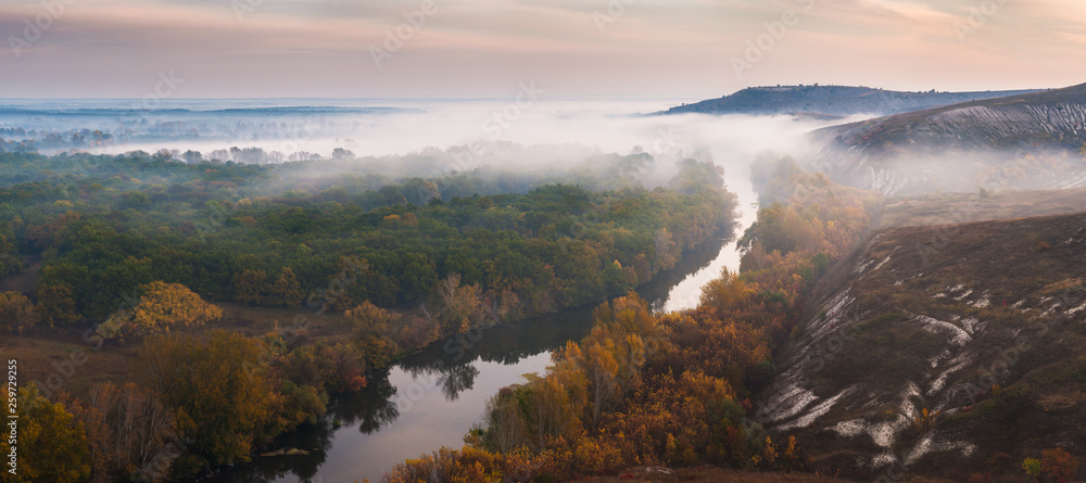 Autumn landscape with fog in valley