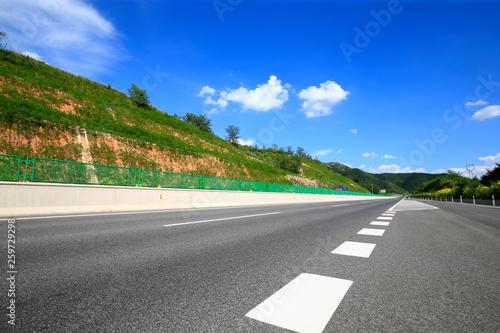Highway, under the background of blue sky and white clouds