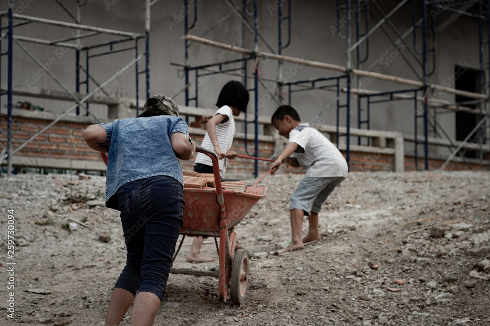 Fototapeta premium Child labor in building commercial building structures. World Labor Day concept