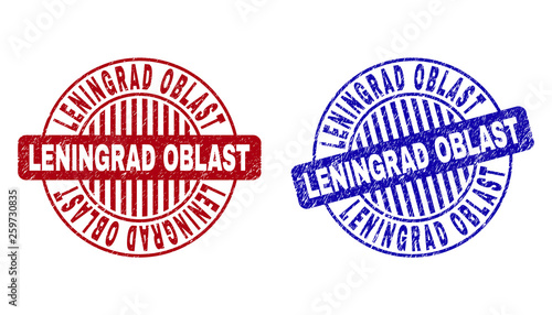 Grunge LENINGRAD OBLAST round stamp seals isolated on a white background. Round seals with grunge texture in red and blue colors.