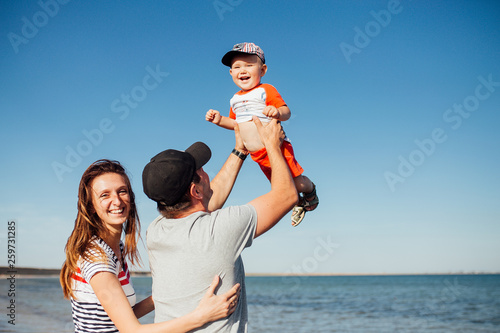 Funny portrait of a happy family on the beach.