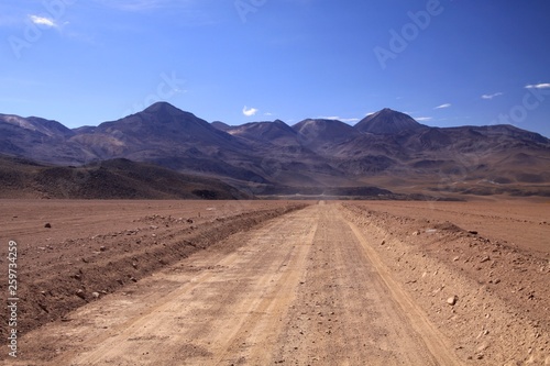 Straight endless dirt road in Atacama desert, Chile