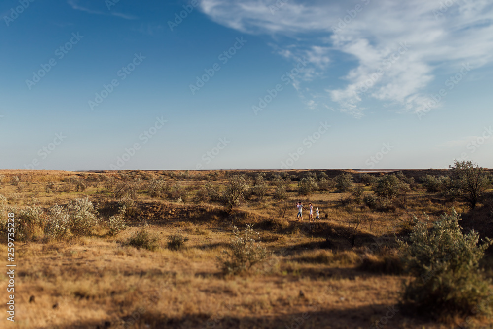 Fototapeta premium Wide angle portrait of a happy family in the field.