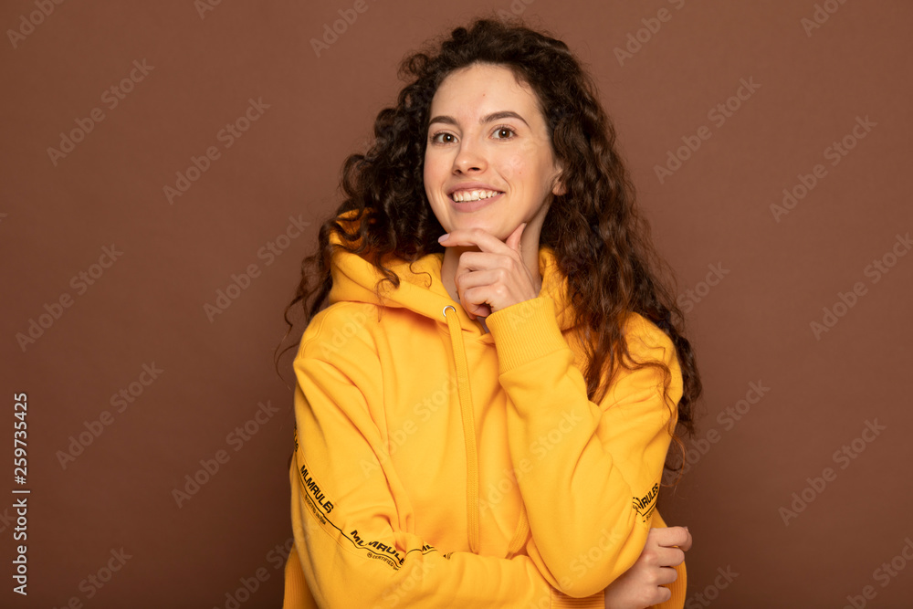 Portrait with copy space empty place of cheerful laughter funny comic girl . Beautiful american girl with an afro hairstyle smiling. Happy woman with curly hair. sincere girl Portrait with copy space empty place of cheerful laughter funny comic girl . Beautiful american girl with an afro hairstyle smiling. Happy woman with curly hair. sincere girl