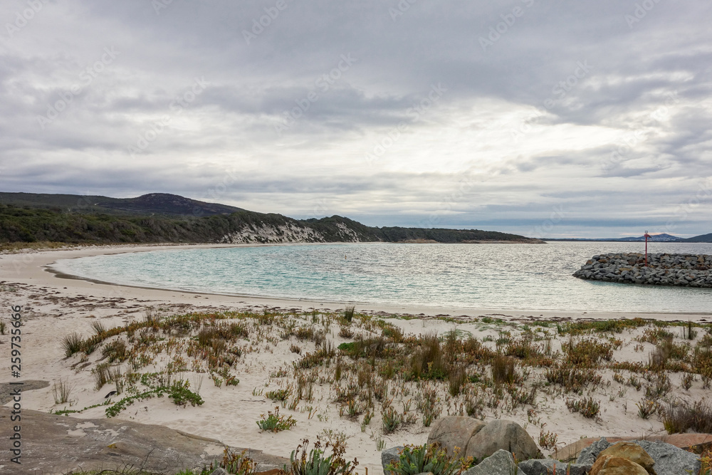 The bay in Albany with azure water and grey cloudy sky during sunset