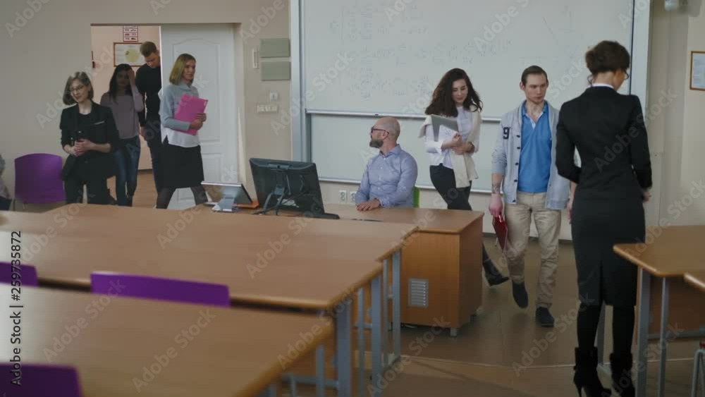 Multinational group of students entering auditorium Multinational group of students entering auditorium