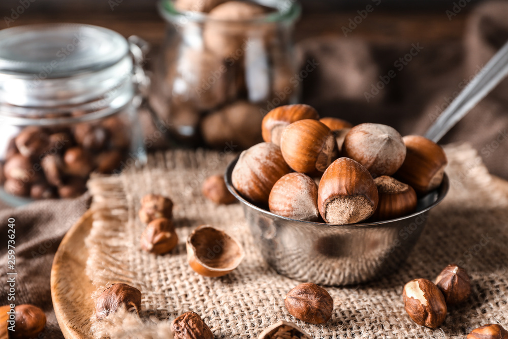 Ladle with tasty hazelnuts on table, closeup Ladle with tasty hazelnuts on table, closeup