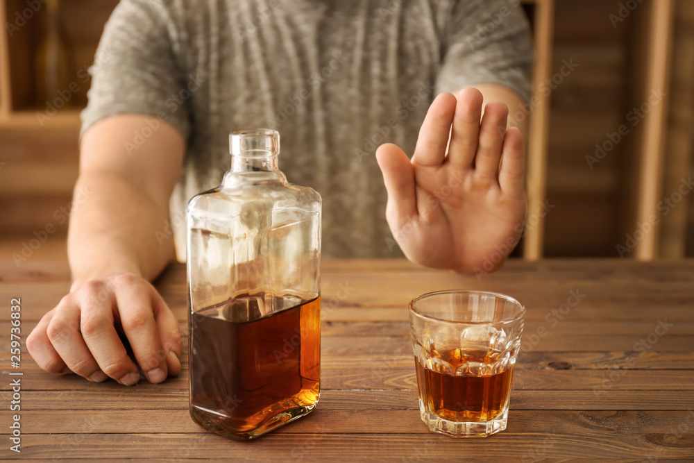 Man refusing to drink whisky in bar Man refusing to drink whisky in bar