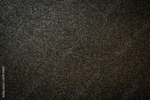 Metallic glitter black background, close up. Dark gray paper backround. Black glitter background from wrapping paper.