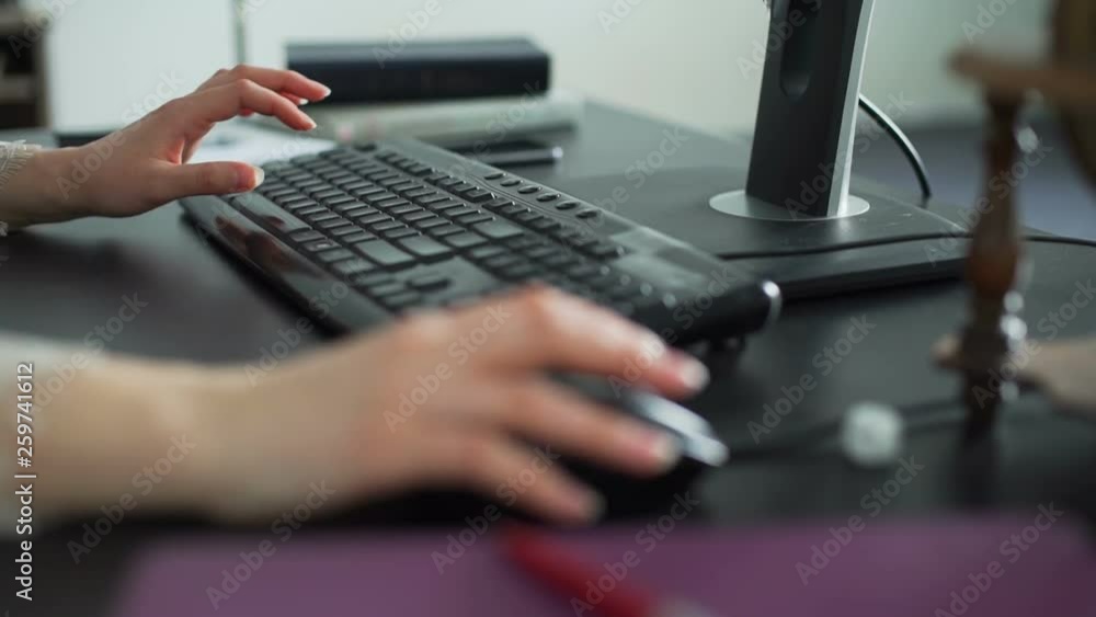 Young Woman Typing on Keyboard in Office Young Woman Typing on Keyboard in Office