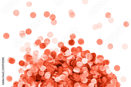 Bright coral confetti isolated on white background.