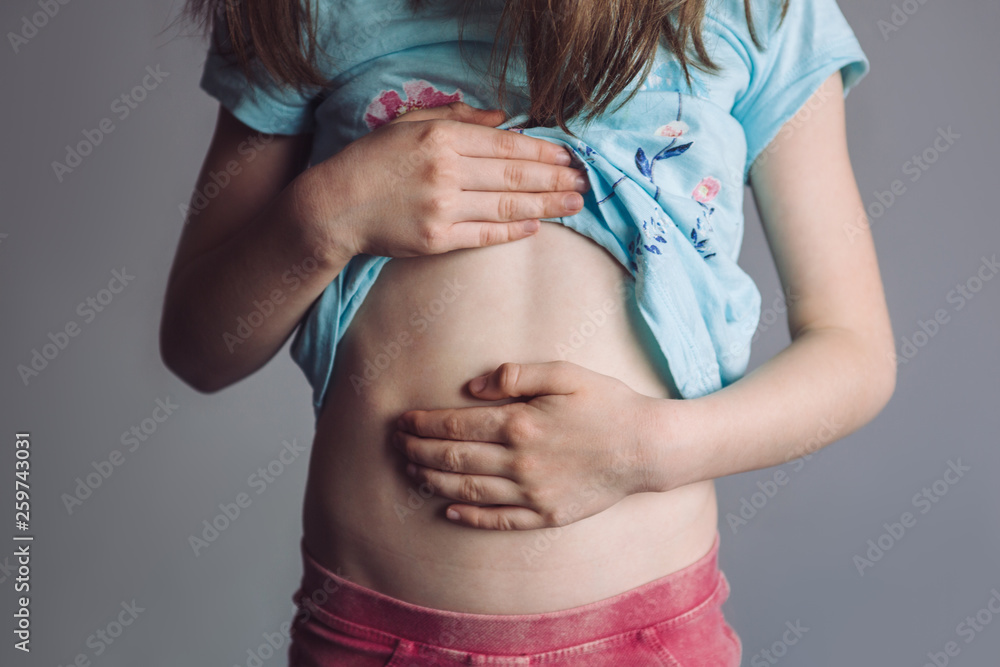 Cute little girl suffering from stomach ache