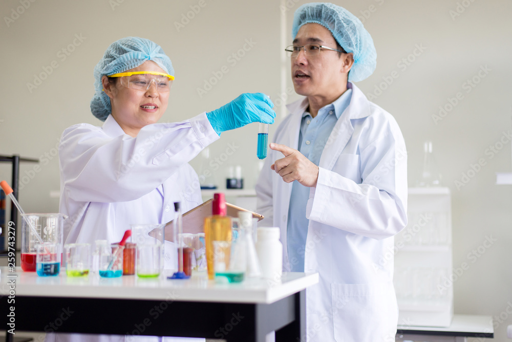Scientist working analysis putting medical chemicals sample in test tube at lab together Scientist working analysis putting medical chemicals sample in test tube at lab together