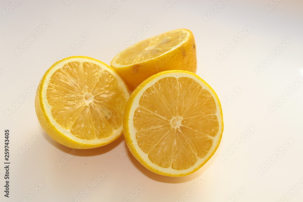 Lemons, cut into three parts, lie on a white background Lemons, cut into three parts, lie on a white background