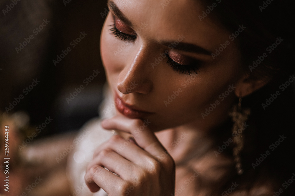 Closeup portrait of a young beautiful woman bride in a beige flesh-colored dress with lace. Hard light and shadow, dramatic gentle. Closeup portrait of a young beautiful woman bride in a beige flesh-colored dress with lace. Hard light and shadow, dramatic gentle.