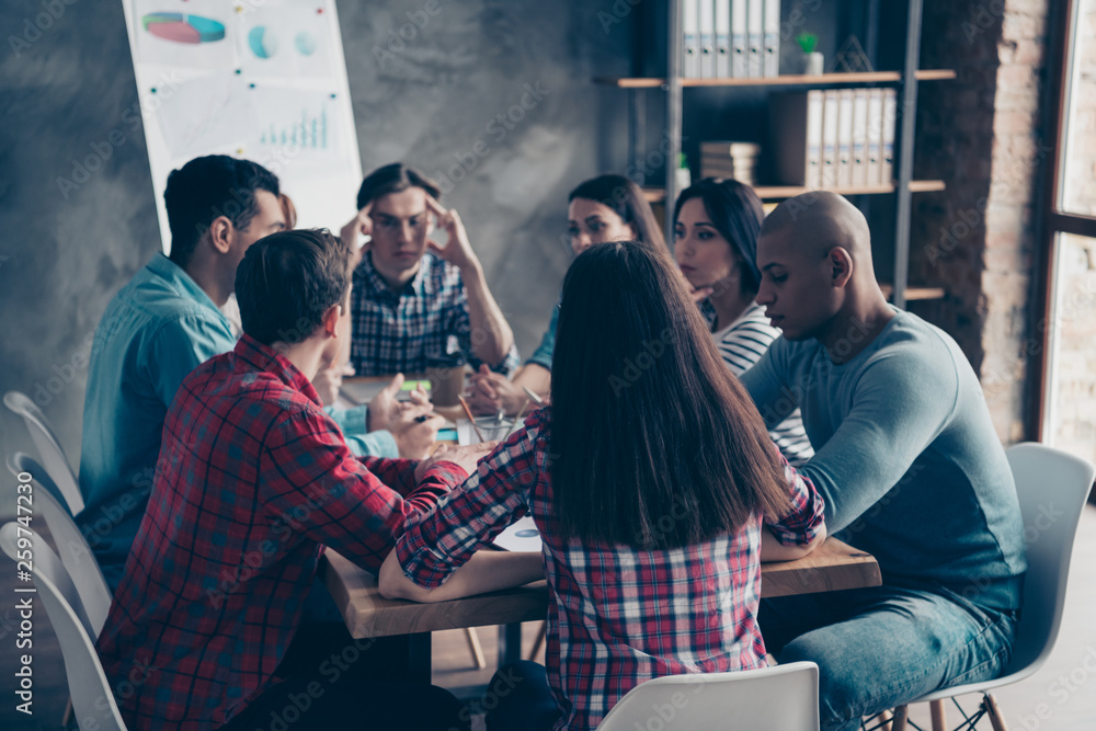 Obraz premium Confident thoughtful leaders leadership thinking about successful strategy having conversation gather together at table wearing checkered casual shirts 