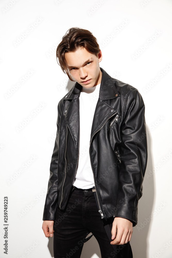 Fashion portrait of young cool hipster boy. Studio shot of model having serious face. Fashion portrait of young cool hipster boy. Studio shot of model having serious face.