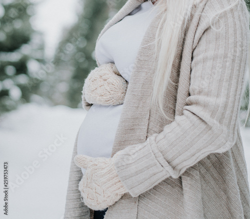 pregnant woman in winter scene with comfy clothing