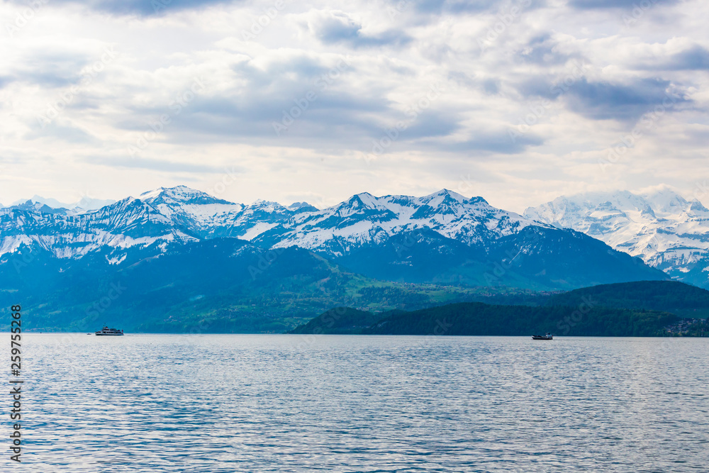 Travel ship in lake Thun and view of Bernese Alps mountain Berne, Switzerland Travel ship in lake Thun and view of Bernese Alps mountain Berne, Switzerland