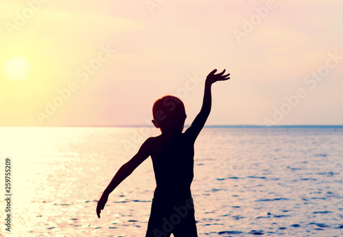 Child Silhouette with Hand Up photo