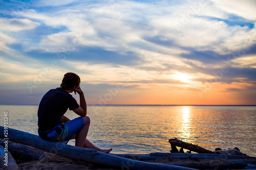Canvas Print Lonely Young Man at Seaside