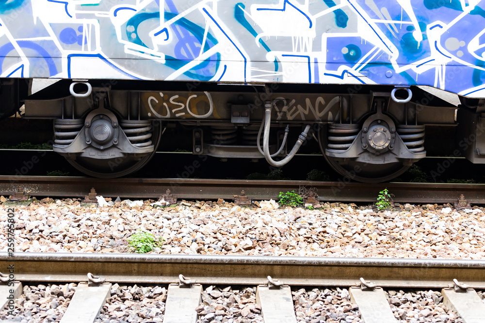 Close up of steel train wheel on rail track Close up of steel train wheel on rail track