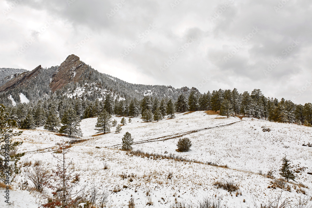 A Spring snow storm covers the mountain range, valley and Flatirons of Chautauqua Park, in Boulder, Colorado