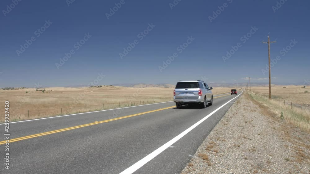 Cars on highway with electricity poles on the side, California, USA Cars on highway with electricity poles on the side, California, USA