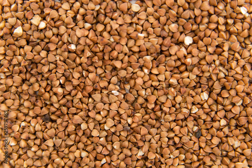 buckwheat groats scattered on white background