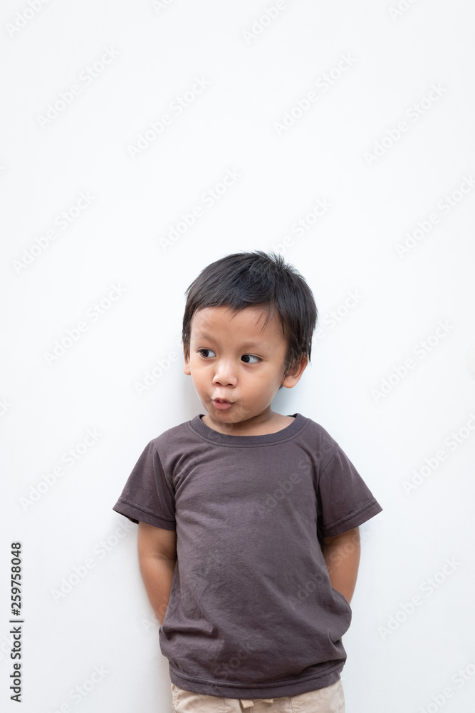 Portrait of a toddler boy with puckering facial expression on white background Portrait of a toddler boy with puckering facial expression on white background