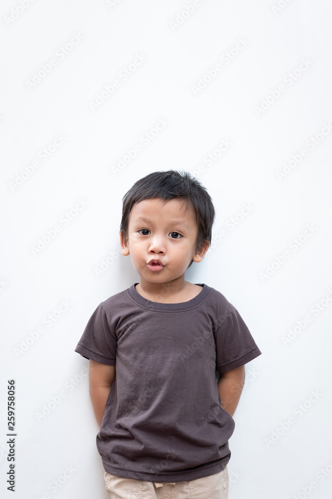 Portrait of a toddler boy with puckering facial expression on white background Portrait of a toddler boy with puckering facial expression on white background