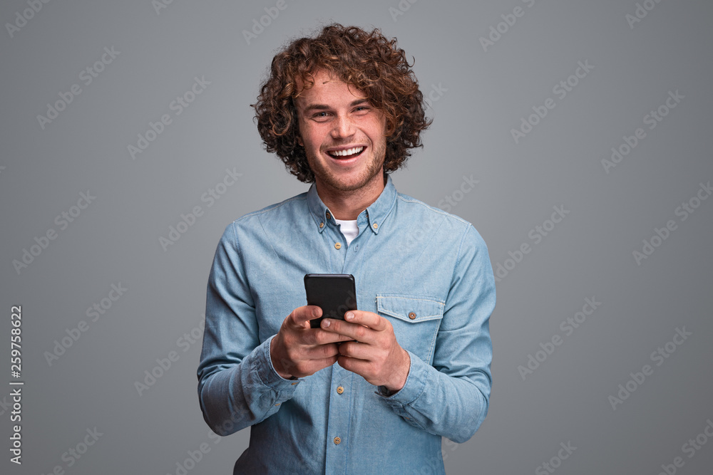 Cheerful man using smartphone Cheerful man using smartphone