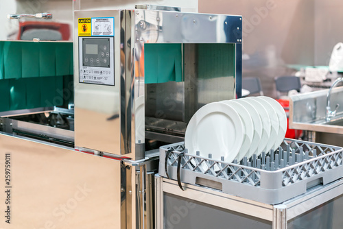 Quadro su tela close up white dish on basket in automatic dishwasher machine for industrial
