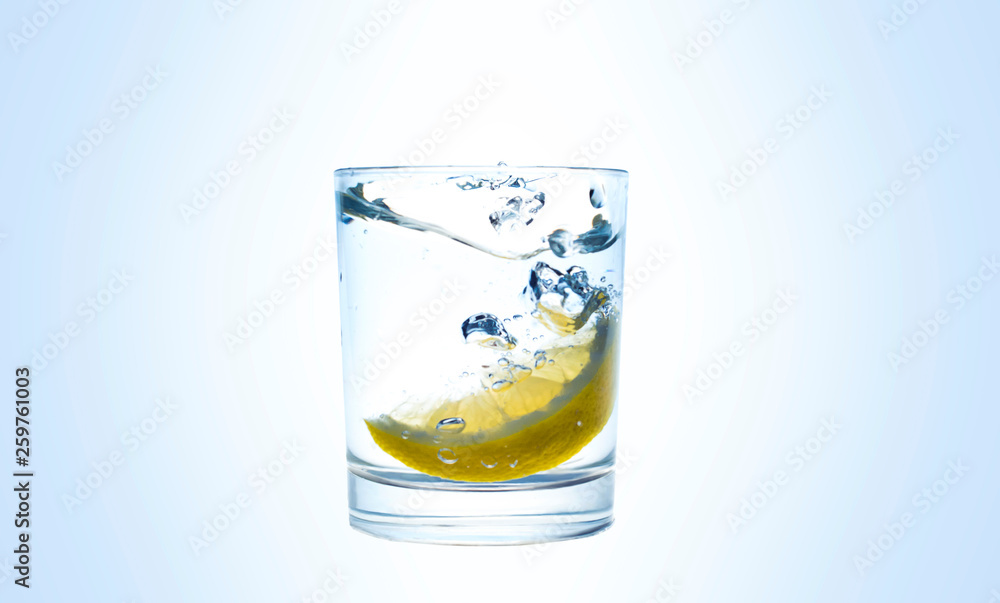 Lemon splashes in a water glass