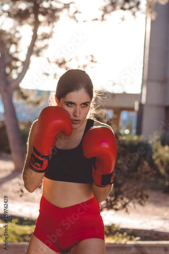 young woman boxing on the street © aitorserra