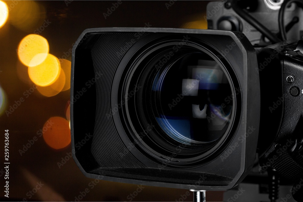 Close-up of a television camera lens on blurred background, bokeh