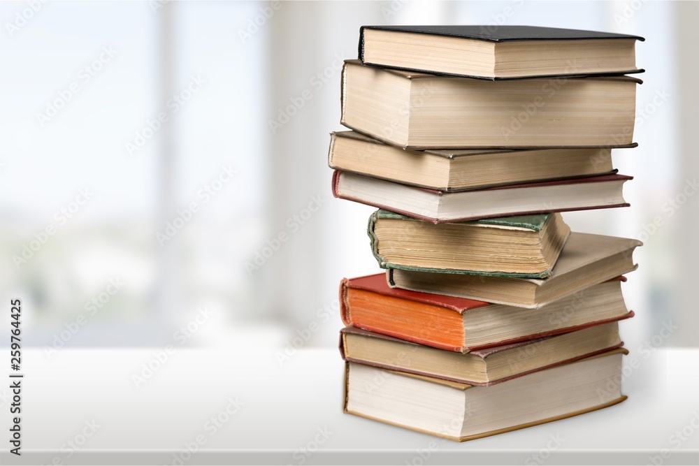 Stack of books with laptop on table Stack of books with laptop on table
