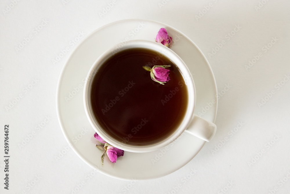 Cup of roses tea with rose