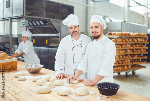 Men bakers in the workplace in the bakery