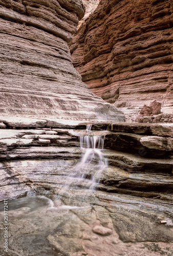 Water falls down slot canyon, Matkatamiba Canyon, Grand Canyon National Park, Arizona