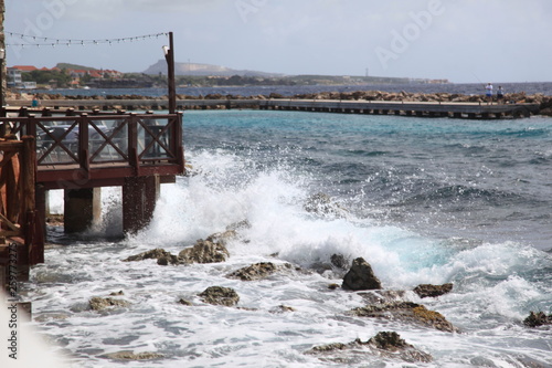 waves crashing into a bridge