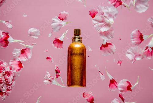 carnation flower petals and perfume bottle photo