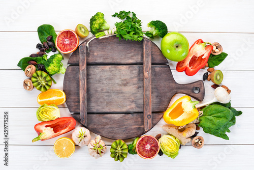 Food containing natural vitamin C: Orange, lemon, apple, rose, garlic, broccoli, apple, kiwi, spinach. Top view. On a white background.